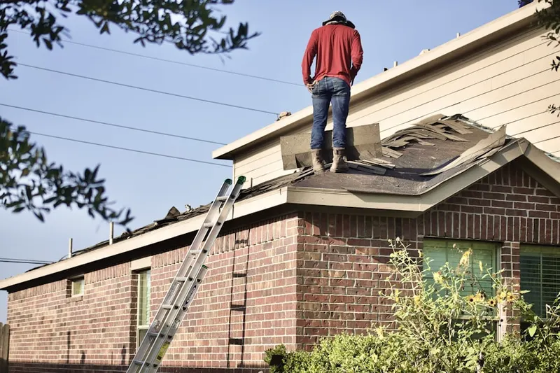 Professional roofer working on a residential roof in Gibsondale